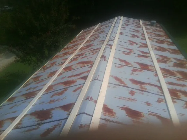 Rusted metal roof panels with new wood purlins before replacement — Storm Damage Roof Repair in West Terre Haute by Roofing Brothers